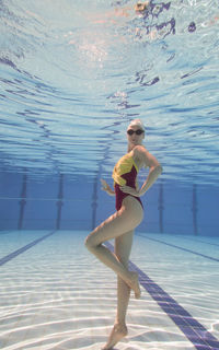 Portrait of young female model posing in pool