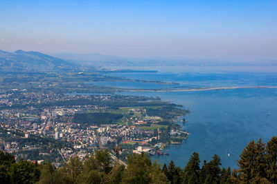 High angle view of townscape by sea against sky