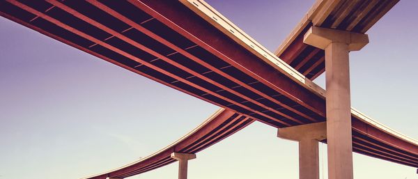 Low angle view of modern bridges against clear sky