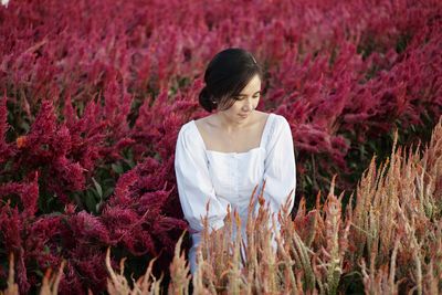 Woman standing on purple flowering plants