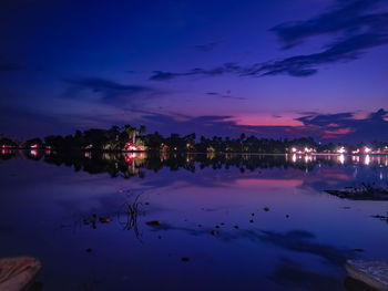 Scenic view of lake against sky at night