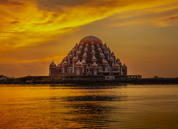 Traditional building against sky during sunset