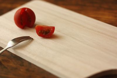 Close-up of cherry tomato on cutting board