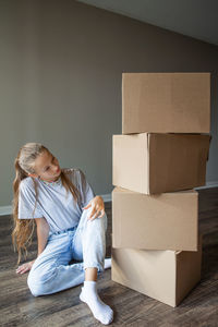 Portrait of boy sitting on cardboard box