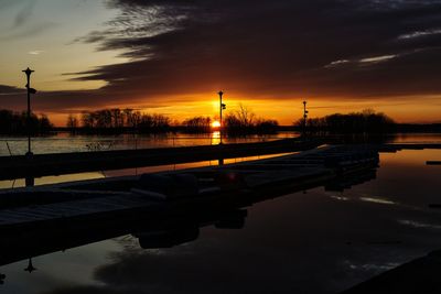 Scenic view of calm lake at sunset