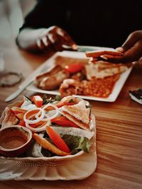 Midsection of person having bread