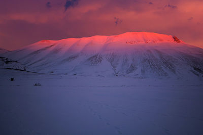 Scenic view of desert against sky during sunset