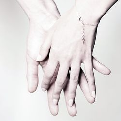 Close-up of human hand against white background