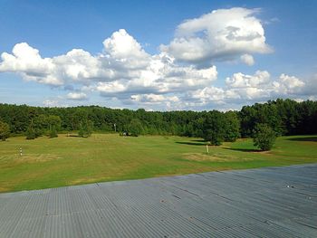 Scenic view of grassy field against cloudy sky