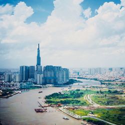 High angle view of city buildings against cloudy sky