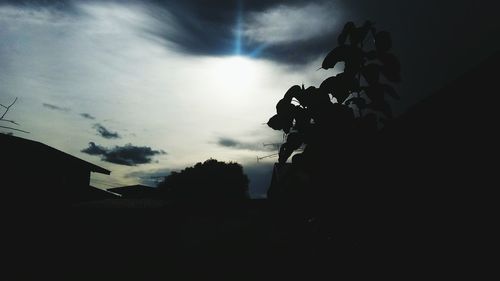 Low angle view of silhouette building against sky