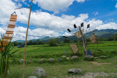 Traditional windmill on field against sky