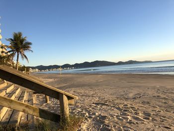 Scenic view of beach against clear blue sky