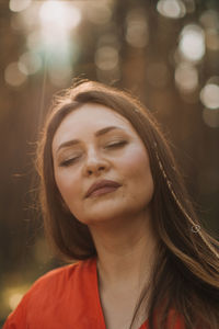 Peace of mind, breathing fresh air. alone woman in red dress enjoys the tranquility and calm