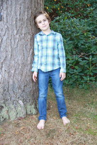 Portrait of boy standing in grass