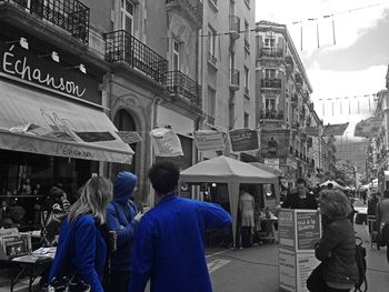 Rear view of people walking in city