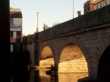 Arch bridge over river in city