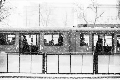 Train during snowfall against sky