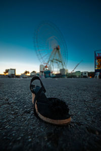 Close-up of amusement park ride against blue sky