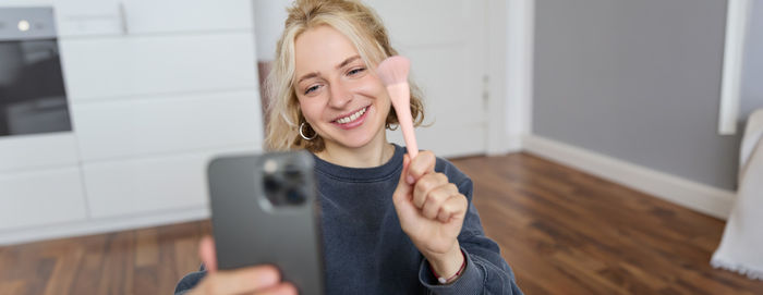 Portrait of young woman using mobile phone