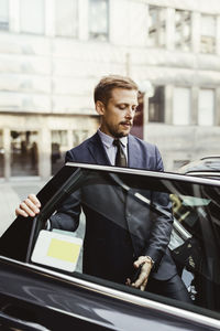 Male entrepreneur entering in car