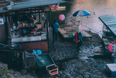 People at market stall building