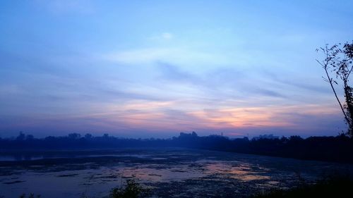 Scenic view of beach against sky during sunset