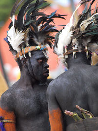 Midsection of man holding feather