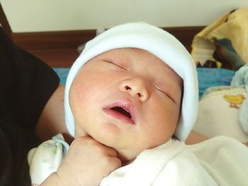 Cropped image of person holding newborn baby