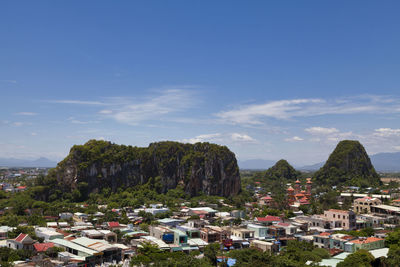 Buildings in town against sky