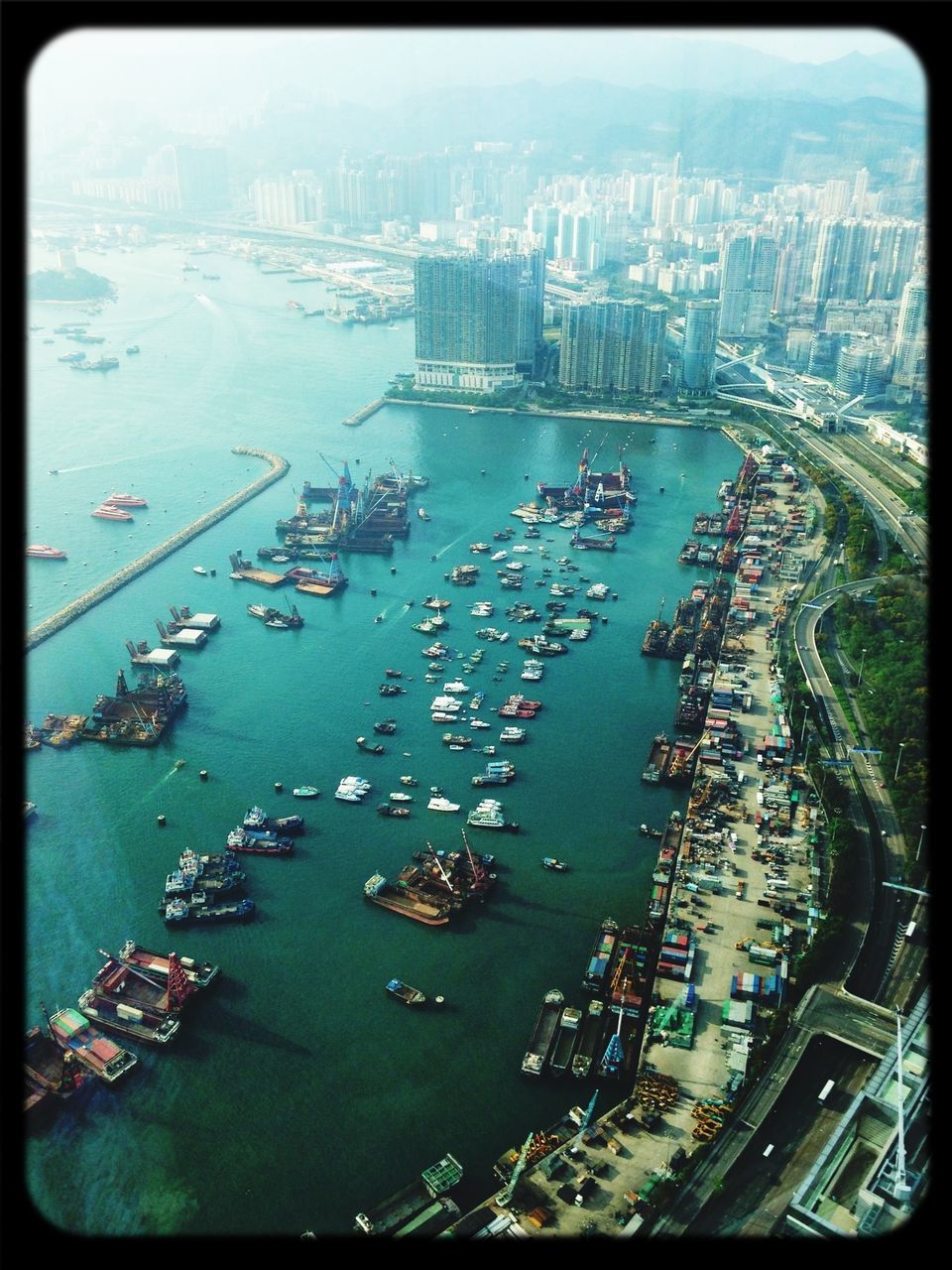 city, building exterior, architecture, cityscape, transportation, built structure, high angle view, water, mode of transport, transfer print, nautical vessel, harbor, aerial view, river, city life, sea, crowded, auto post production filter, boat, skyscraper