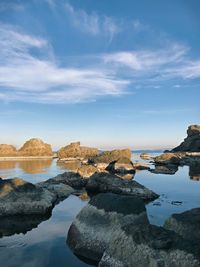 Rocks by sea against sky