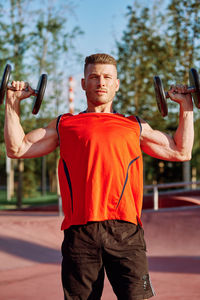 Portrait of young man exercising in gym