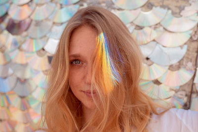 Close-up portrait of woman with light on hair