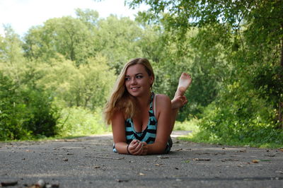 Beautiful woman lying down on road