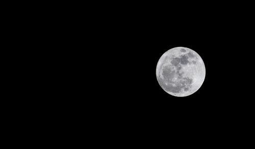 Low angle view of moon against clear sky at night