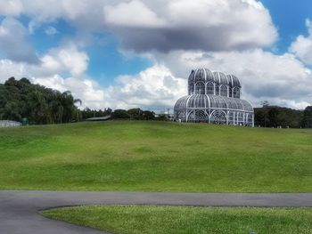 Built structure on field against sky