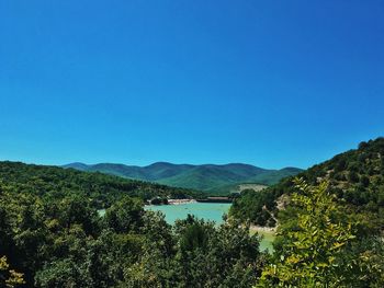 Scenic view of mountains against clear blue sky