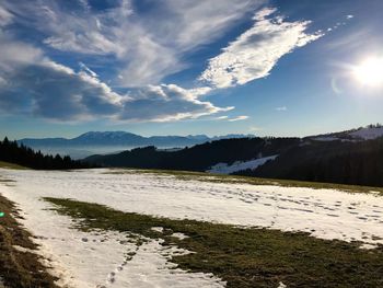 Scenic view of landscape against sky during winter