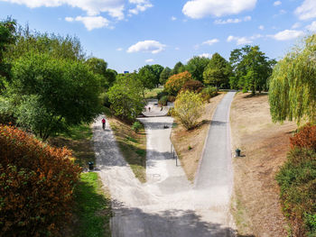 Road amidst trees against sky