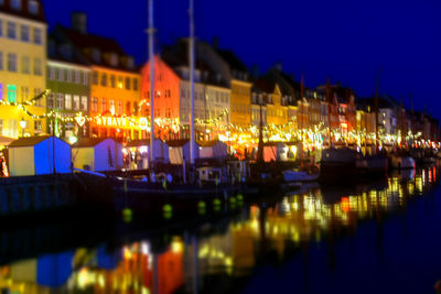 Illuminated harbor against sky at night