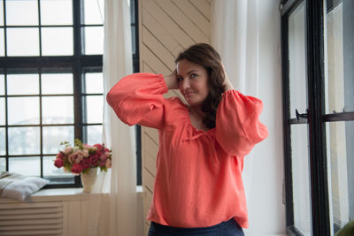 Close-up of young woman standing at home