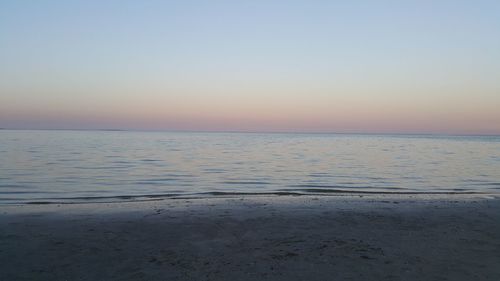 Scenic view of sea against clear sky during sunset