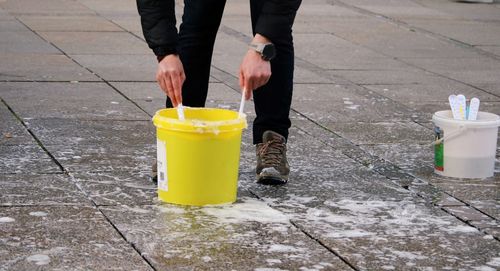 Low section of man standing on street