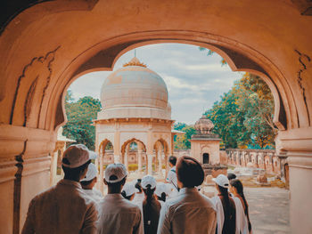 Rear view of people at historical building