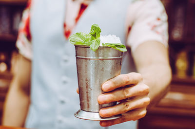 Cropped image of person holding drink