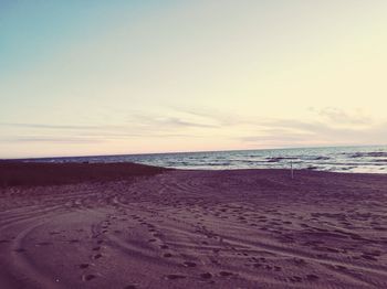 Scenic view of beach against sky during sunset