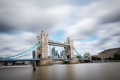 View of bridge over river against cloudy sky