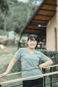 Portrait of woman standing against built structure