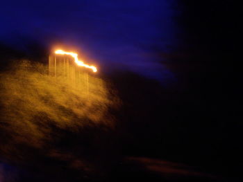 Illuminated lights against sky at night